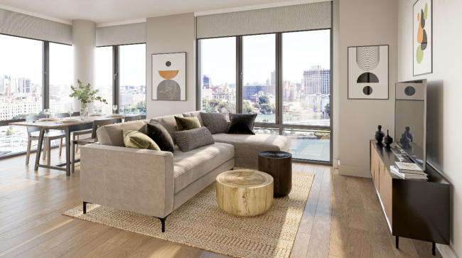 living room with brown sofa, natural colors, wood floors, & large windows overlooking water